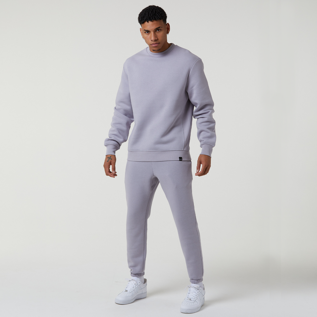 Male model wearing the Faded mens plain tracksuit in grey